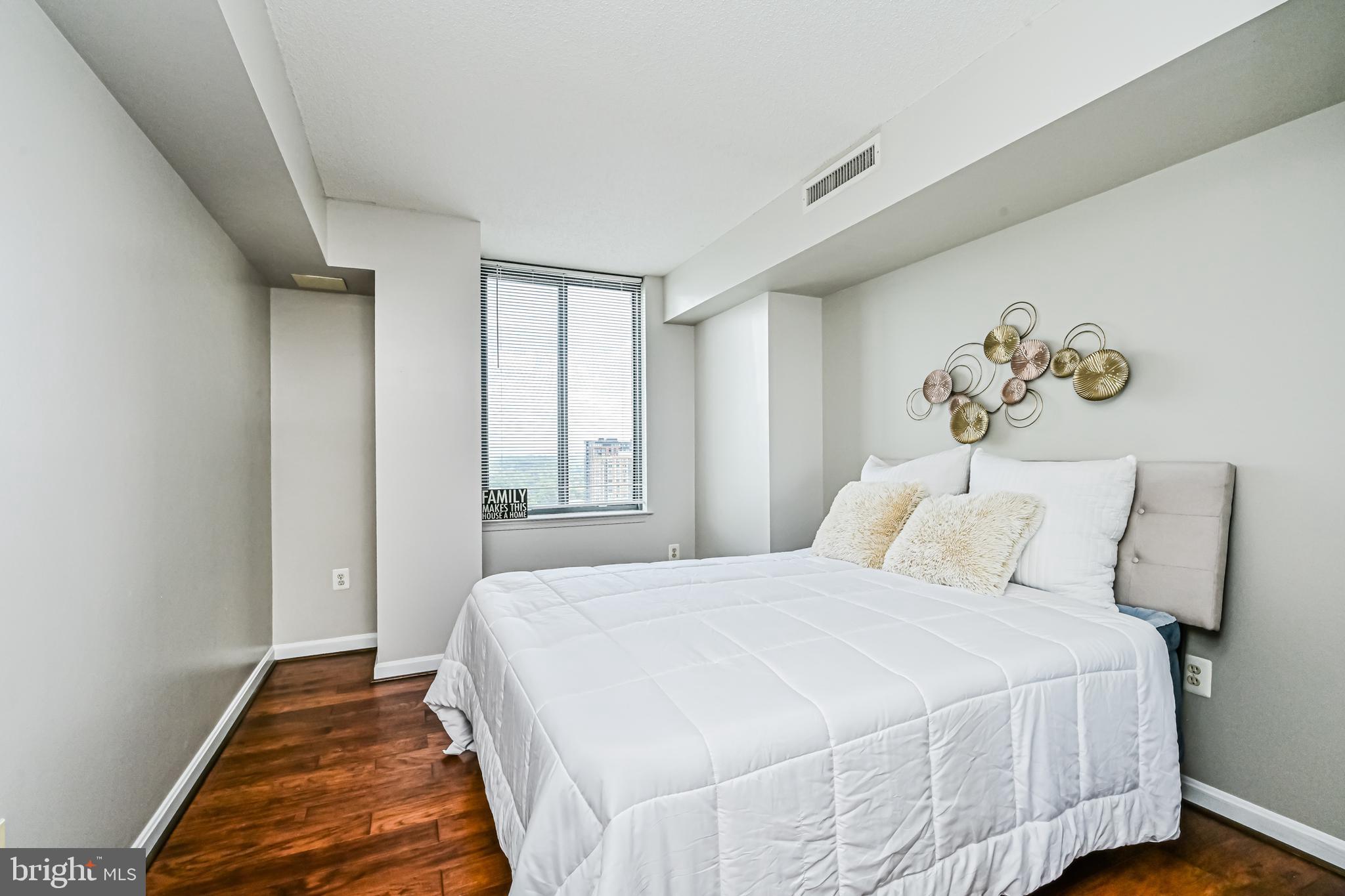 11710 Old Georgetown Road, Unit 1212 Rockville, MD 20852 - Photo 29 of 55 a bedroom with a bed and a window