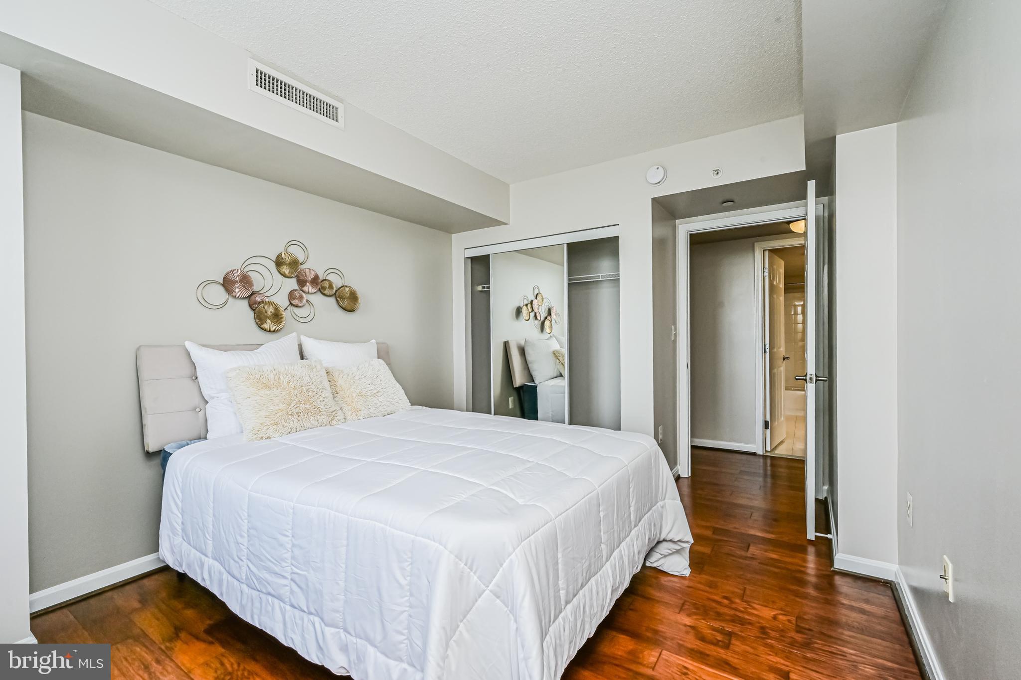 11710 Old Georgetown Road, Unit 1212 Rockville, MD 20852 - Photo 30 of 55 a bedroom with a bed and a painting on the wall