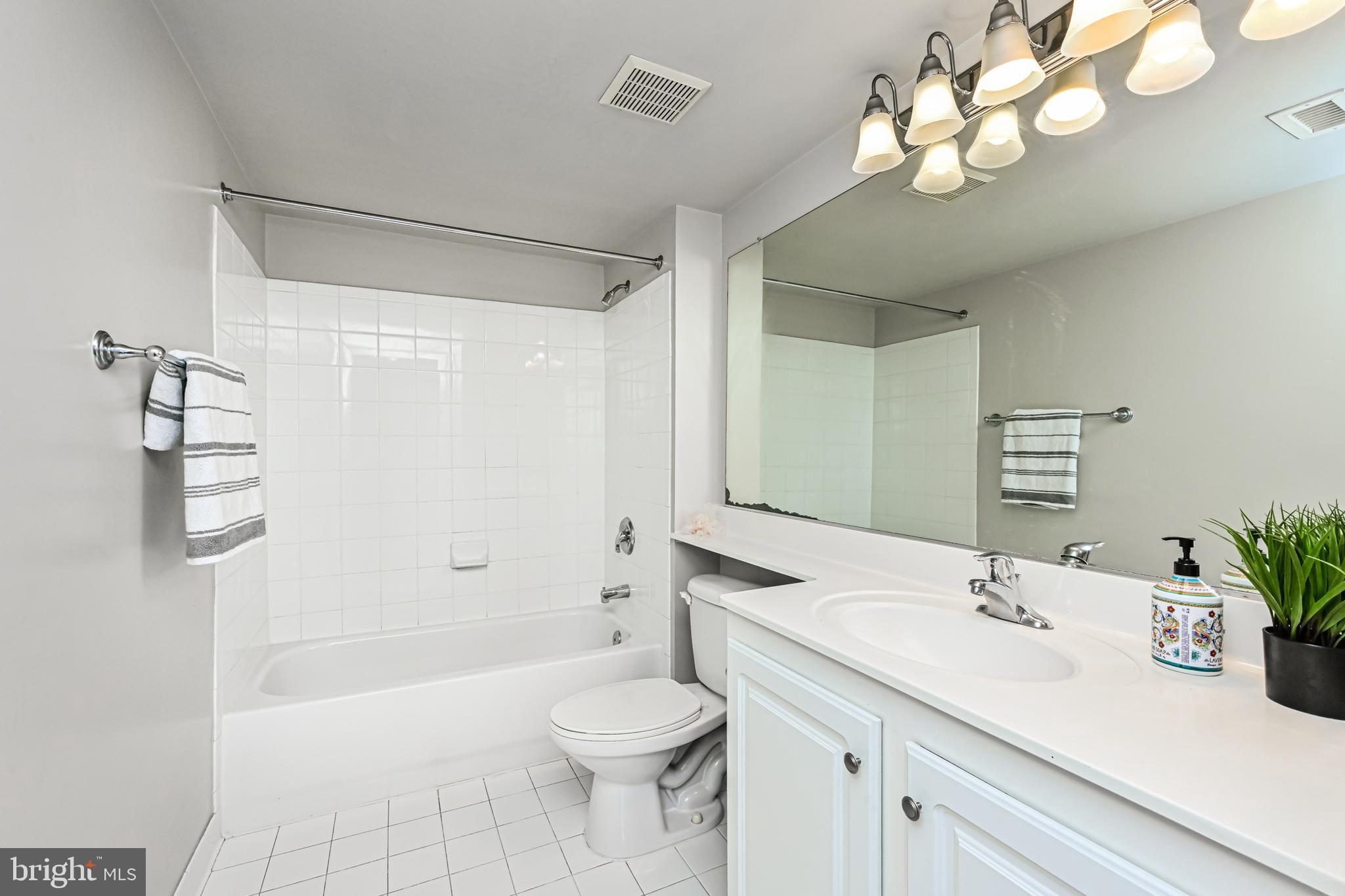 11710 Old Georgetown Road, Unit 1212 Rockville, MD 20852 - Photo 31 of 55 a bathroom with a sink a toilet and a mirror