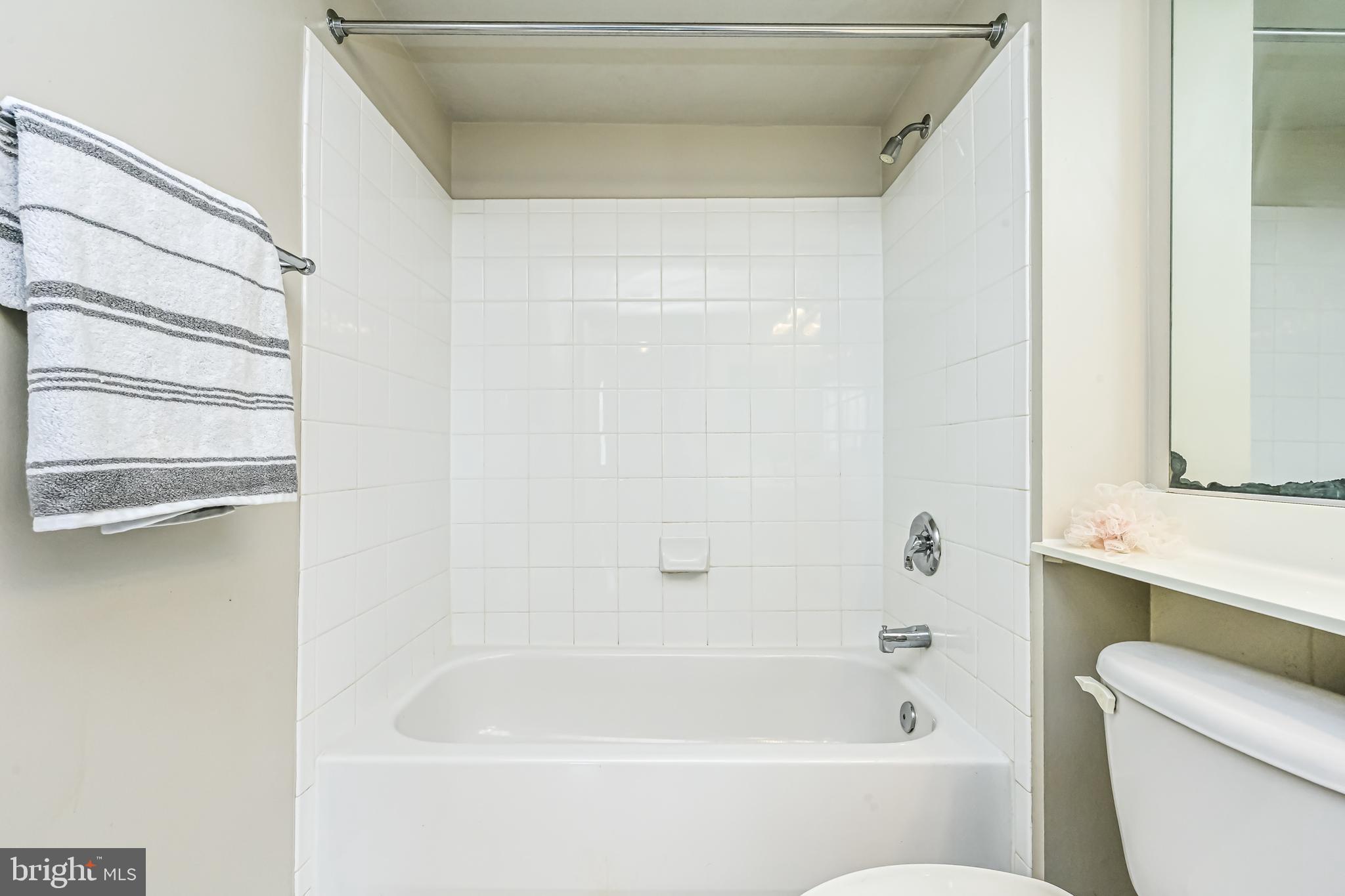 11710 Old Georgetown Road, Unit 1212 Rockville, MD 20852 - Photo 32 of 55 a bathroom with a bathtub and a toilet