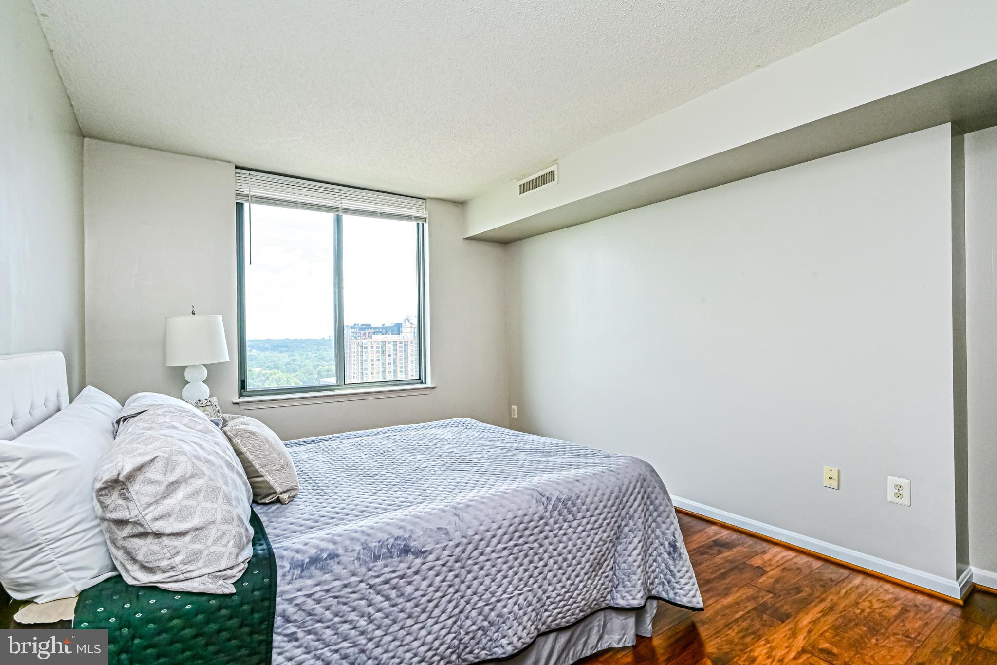 11710 Old Georgetown Road, Unit 1212 Rockville, MD 20852 - Photo 36 of 55 a bedroom with a bed and window