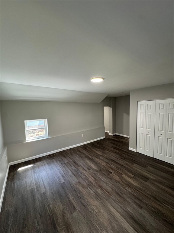 32 Main Street Monson, MA 01057 - Photo 21 of 42 an empty room with wooden floor and windows