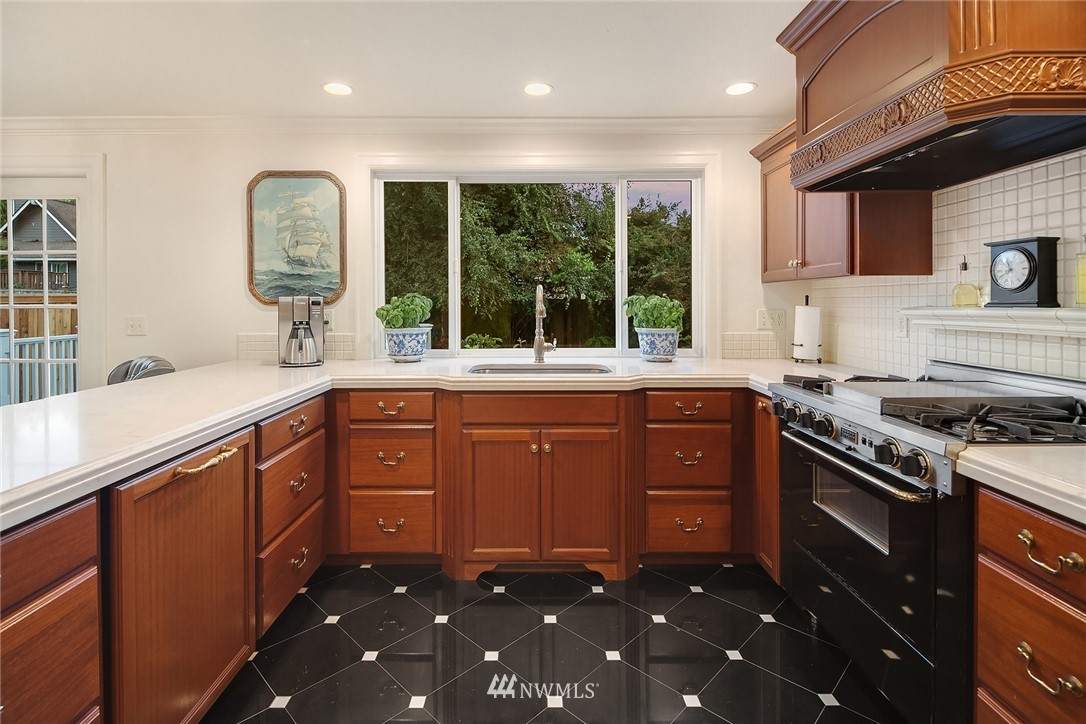 840 Bell Street Edmonds, WA 98020 - Photo 20 of 40 a kitchen with stainless steel appliances granite countertop a sink stove and cabinets
