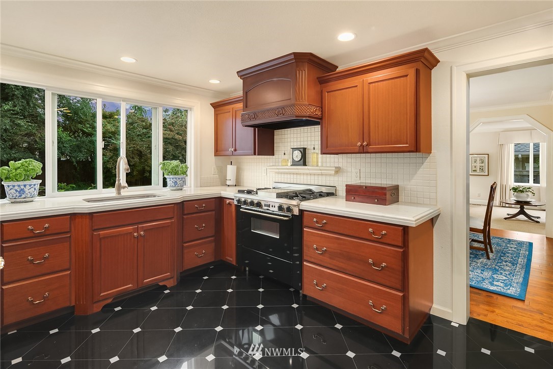 840 Bell Street Edmonds, WA 98020 - Photo 21 of 40 a kitchen with stainless steel appliances granite countertop a stove sink and cabinets
