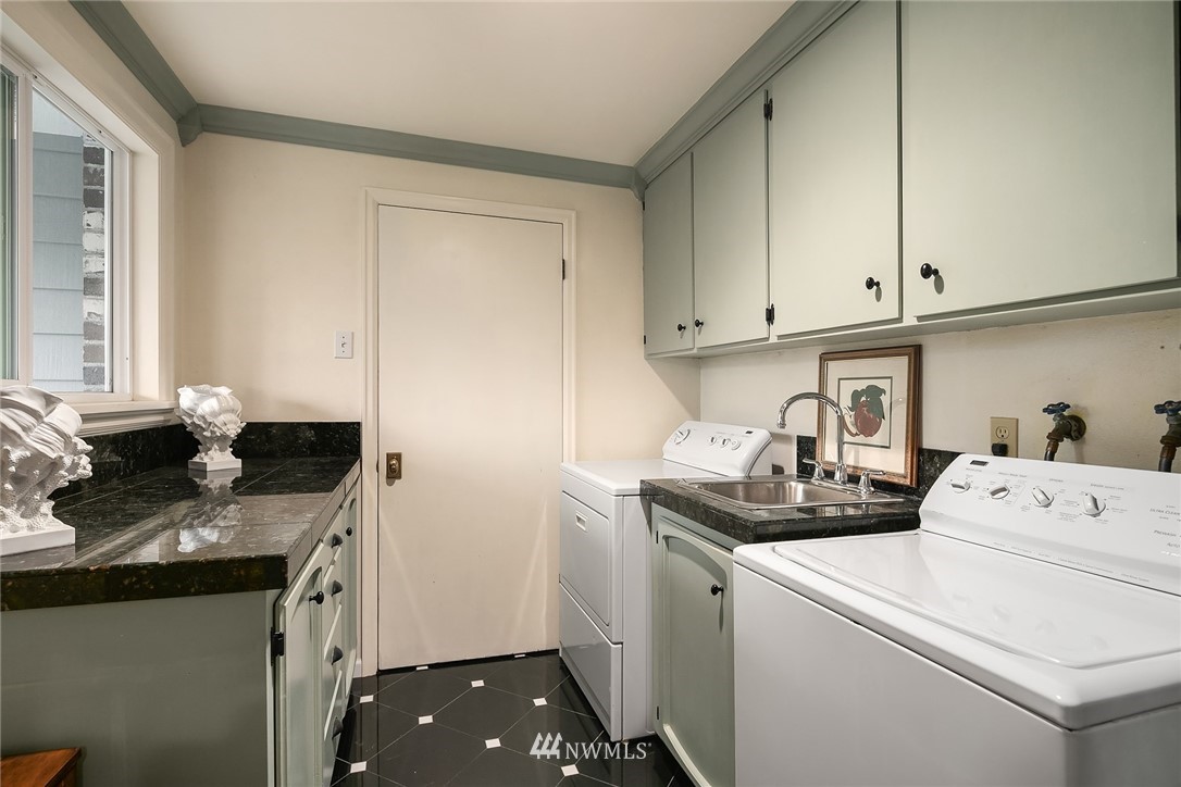 840 Bell Street Edmonds, WA 98020 - Photo 23 of 40 a kitchen with a sink stove and cabinets