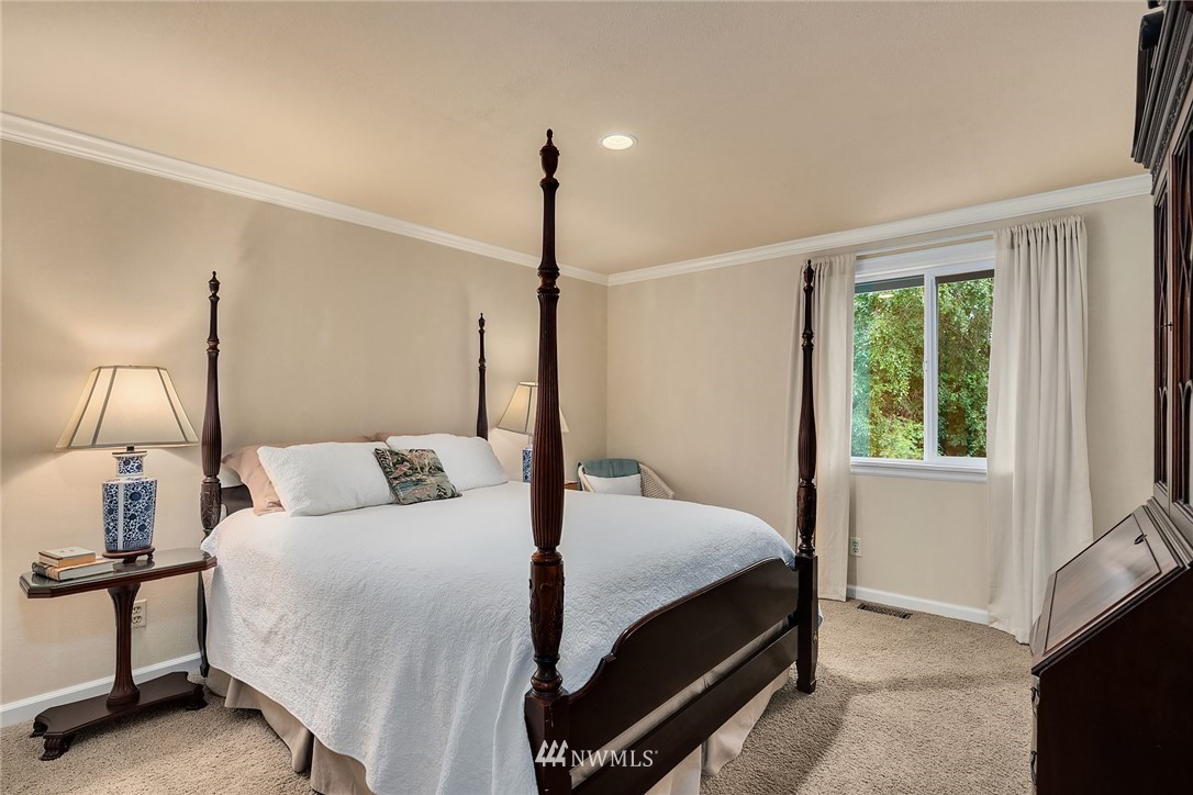 840 Bell Street Edmonds, WA 98020 - Photo 25 of 40 a bedroom with a bed lamp and window