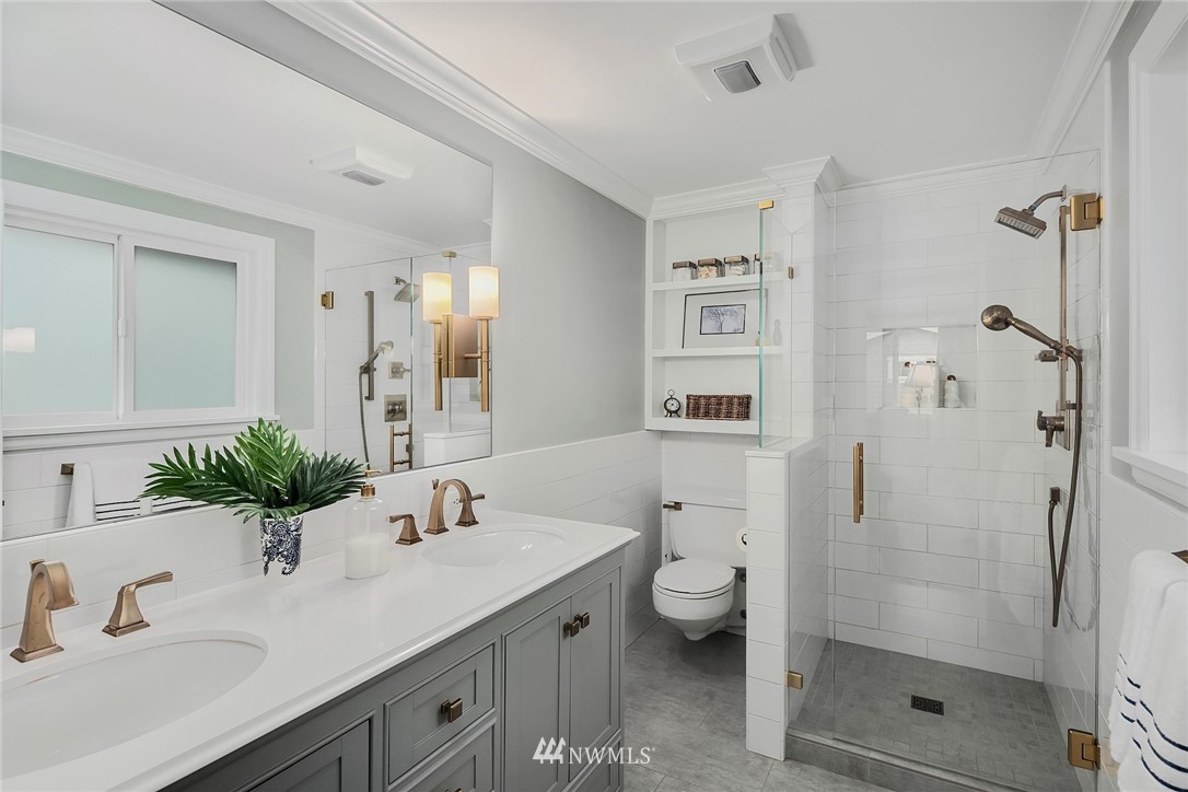 840 Bell Street Edmonds, WA 98020 - Photo 31 of 40 a bathroom with a granite countertop sink a toilet and shower