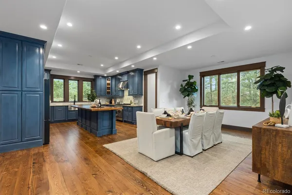 a living room with stainless steel appliances kitchen island granite countertop furniture and a refrigerator