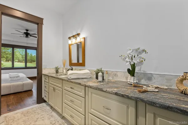 a bathroom with a double vanity sink mirror and shower