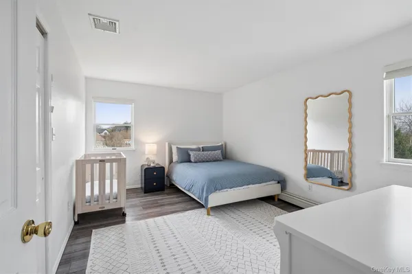 a bedroom with two beds and a dresser