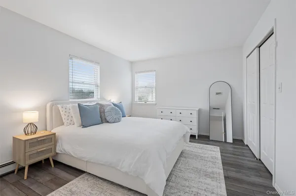 a bed room with a bed and a wooden floor