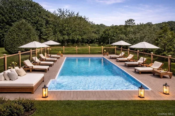 swimming pool view with a seating space
