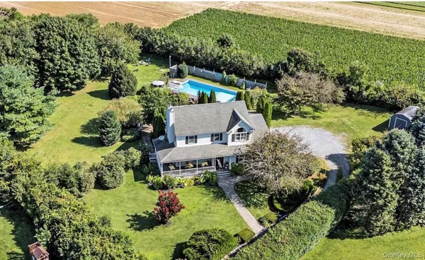 an aerial view of a house with a yard