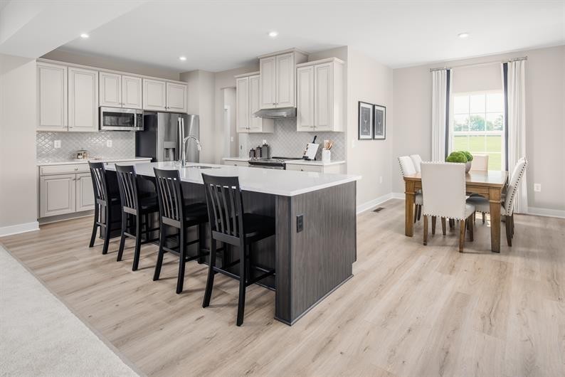 105 Ripplemead Court Gallatin, TN 37066 - Photo 3 of 21 a kitchen with stainless steel appliances granite countertop a table chairs sink refrigerator and cabinets