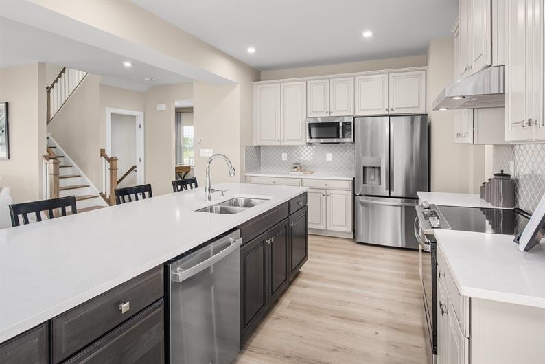 105 Ripplemead Court Gallatin, TN 37066 - Photo 5 of 21 a kitchen with refrigerator cabinets and wooden floor