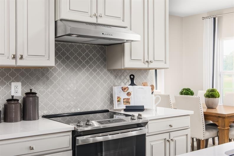 105 Ripplemead Court Gallatin, TN 37066 - Photo 6 of 21 a kitchen with stainless steel appliances a white stove top oven and white cabinets