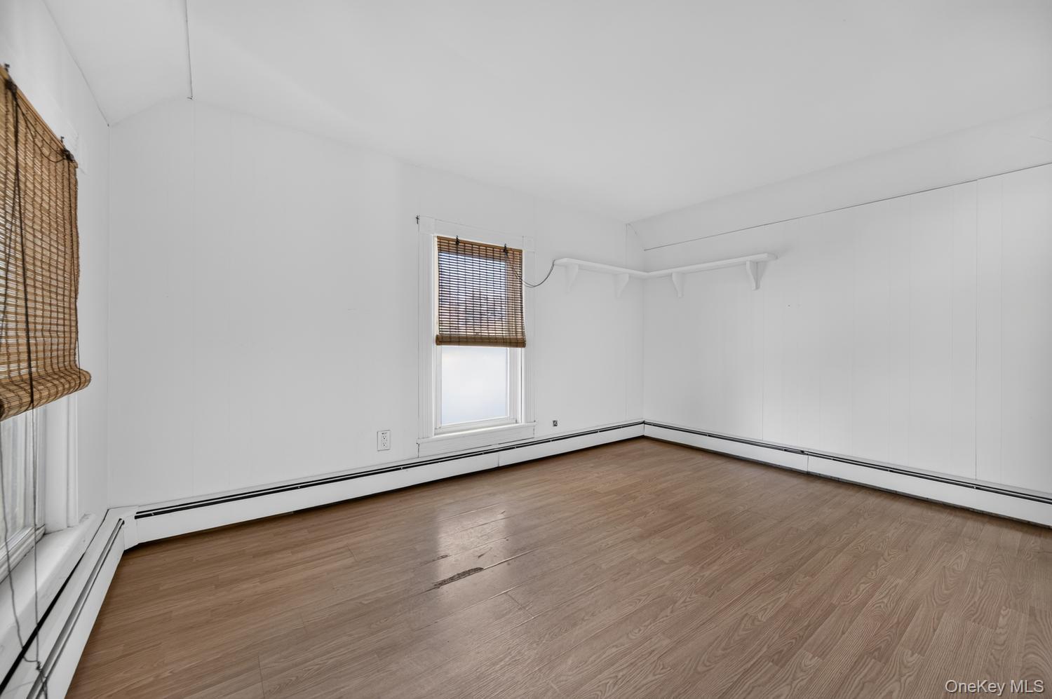 49 Cedar Street Babylon, NY 11702 - Photo 11 of 20 a view of an empty room with wooden floor and a window