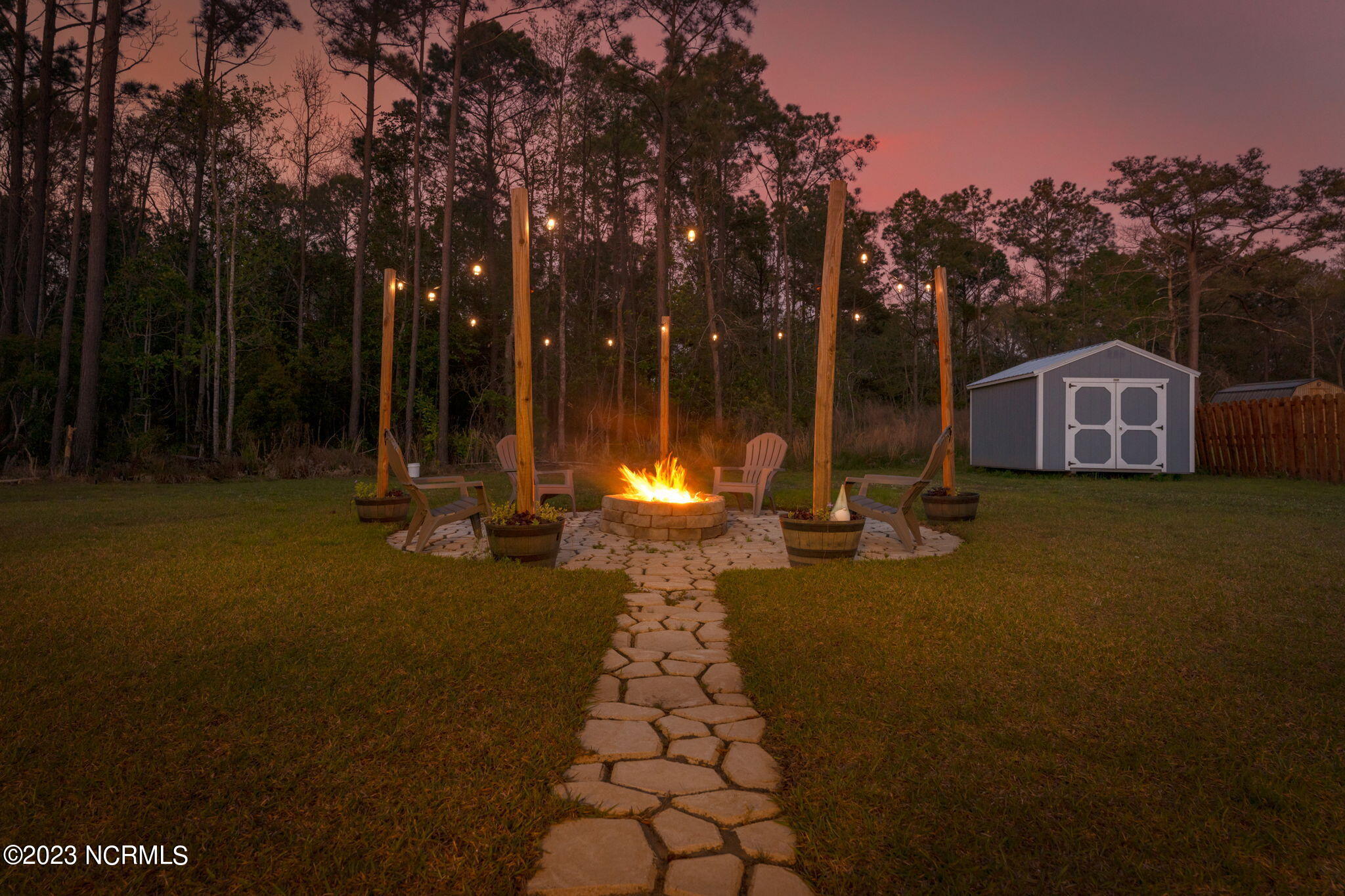 699 Morris Landing Road Holly Ridge, NC 28445 - Photo 3 of 38 3-web-or-mls-twilight-firepit-03