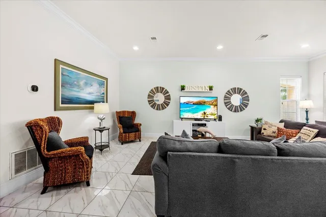 a living room with furniture a rug and a wall painting