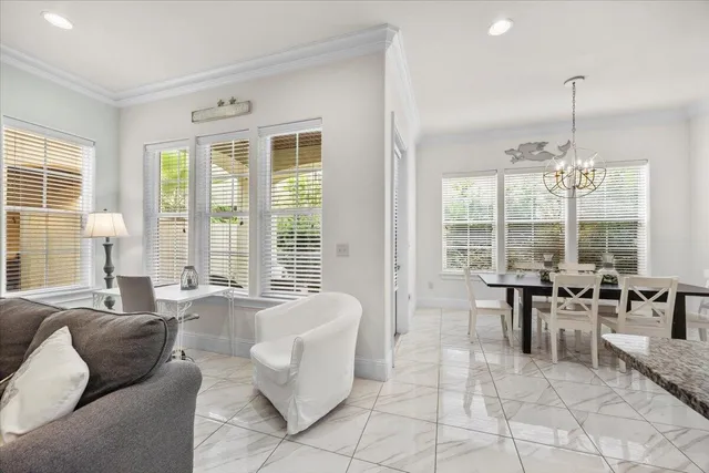 a living room with furniture and floor to ceiling windows