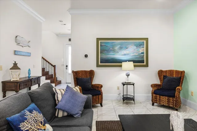 a living room with furniture rug and chair