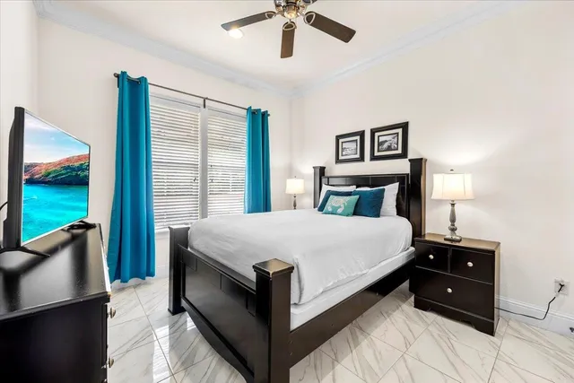 a bedroom with a bed and a chandelier