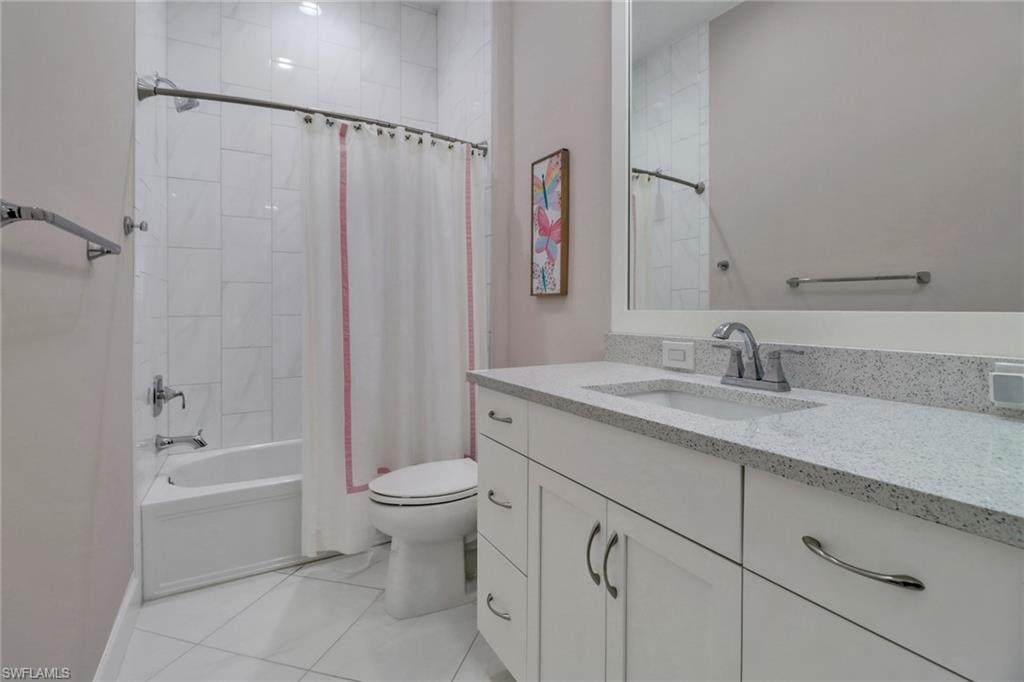 6509 Dominica Drive, Unit 101 Naples, FL 34113 - Photo 18 of 33 a bathroom with a granite countertop sink a toilet and shower