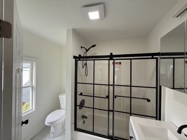 a bathroom with a toilet sink and shower