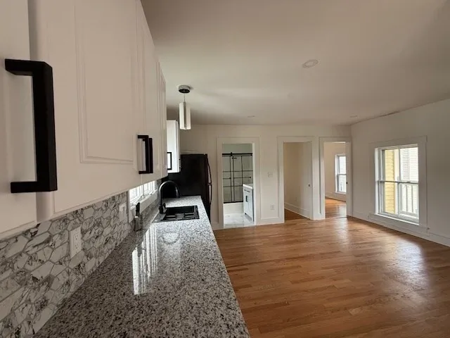 a view of a living room with wooden floor