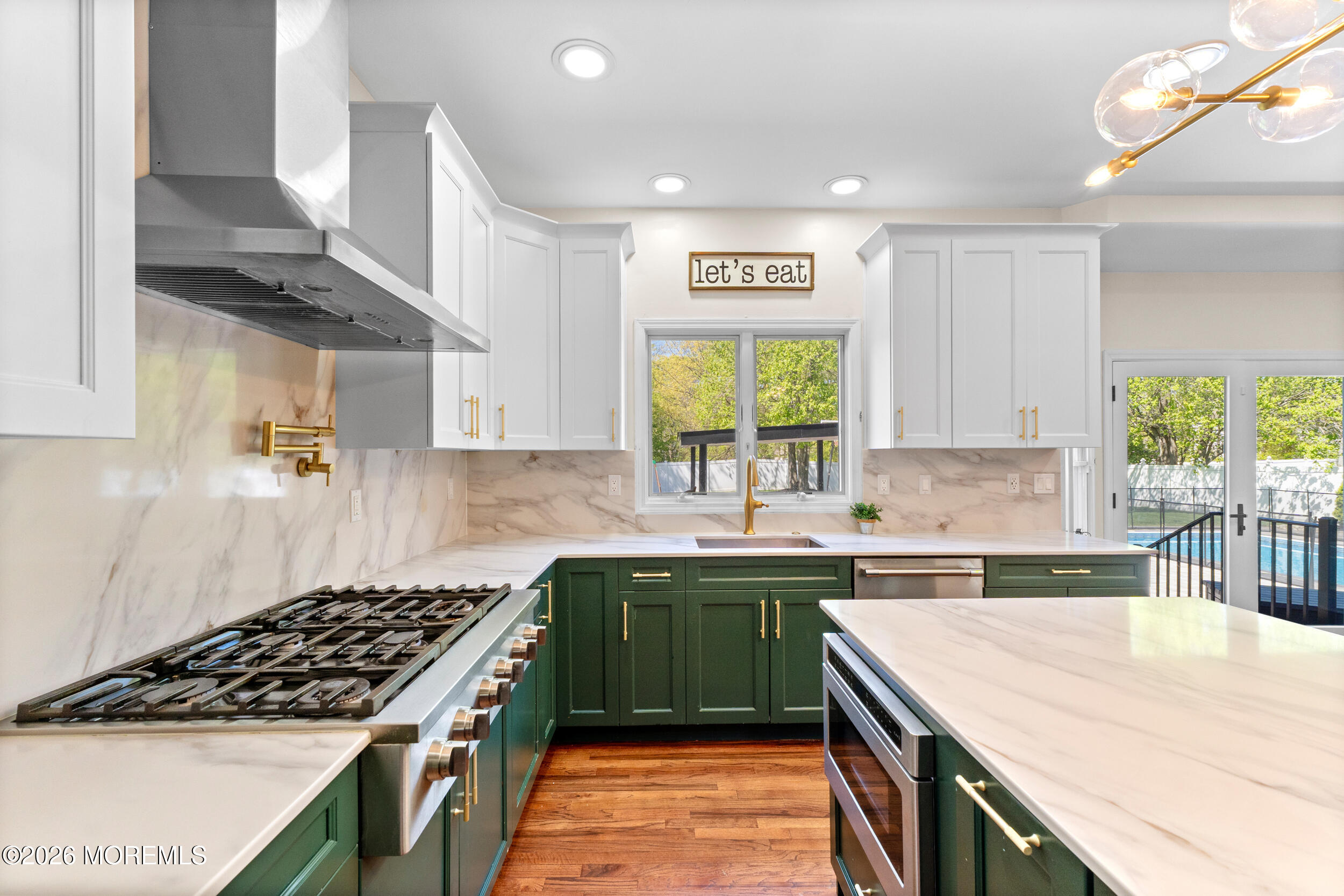 104 Autumn Road Matawan, NJ 07747 - Photo 12 of 64 a kitchen with a sink a stove cabinets and a window