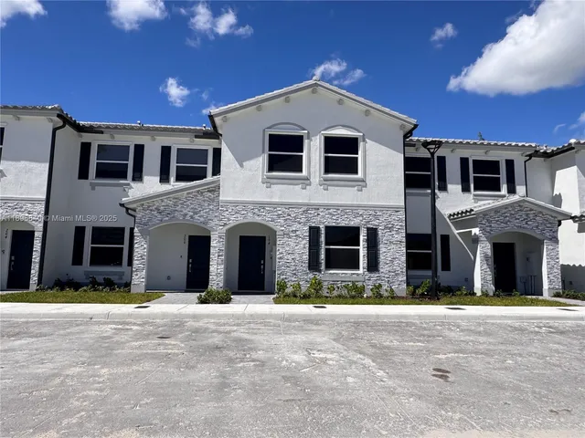 a front view of a house with yard and garage