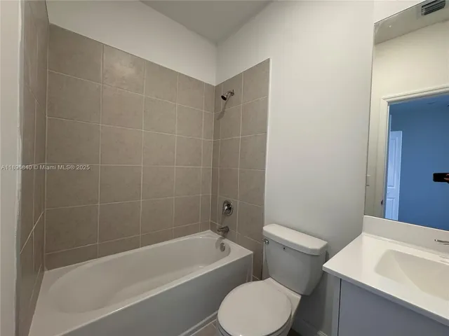 a bath room with a toilet a sink and a bath tub