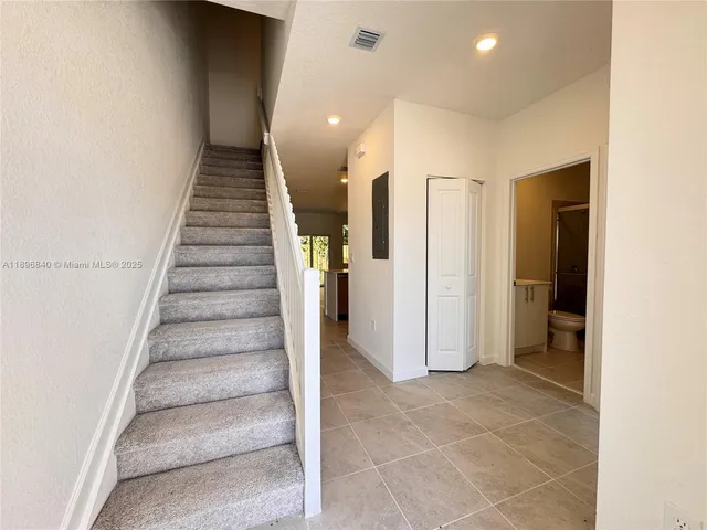 a view of entryway with furniture and wooden floor