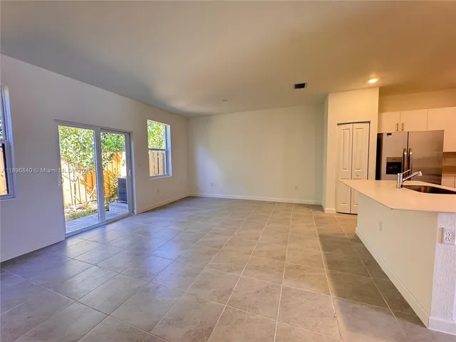 a view of a kitchen with a sink and a window