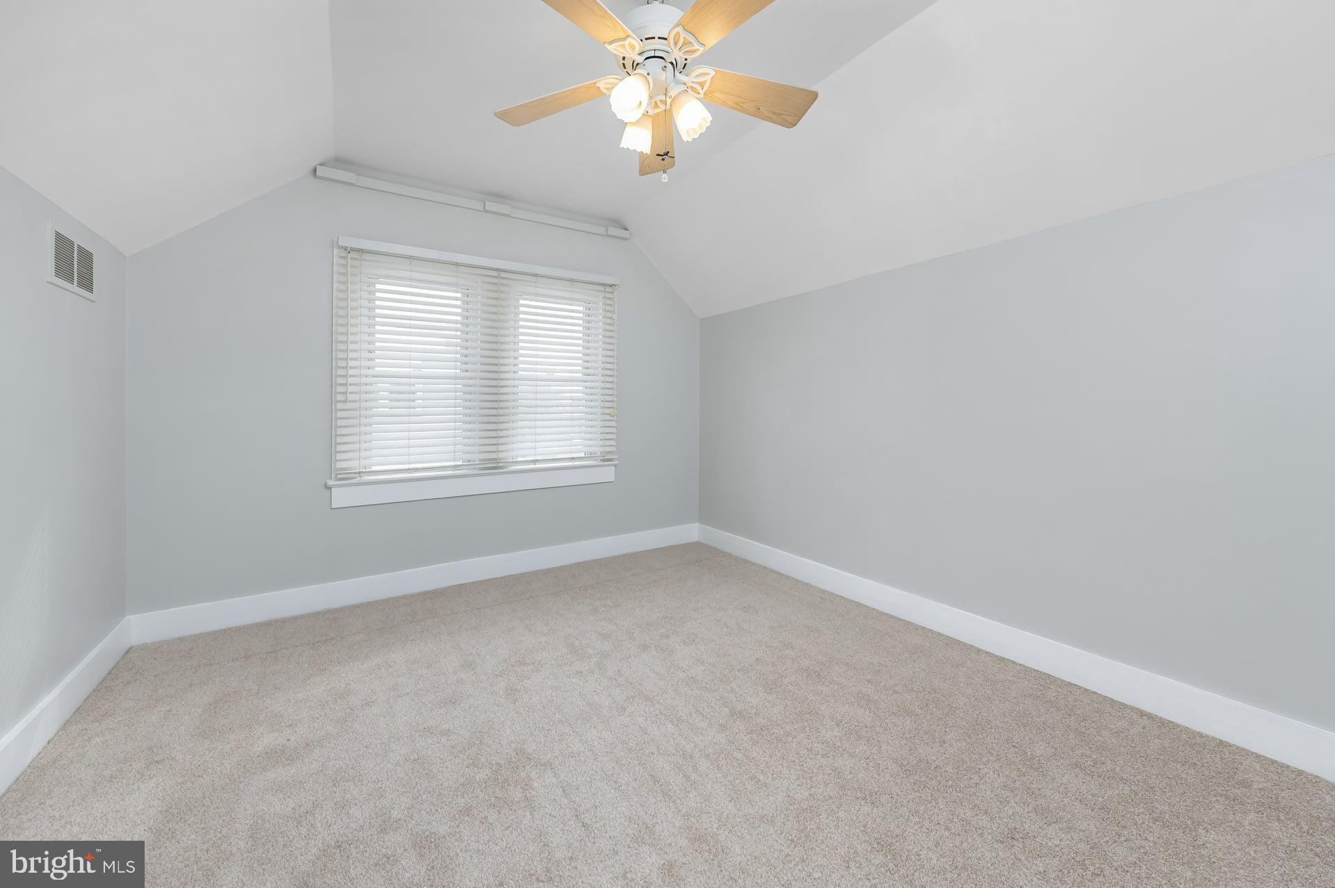 411 Ives Avenue Carneys Point, NJ 08069 - Photo 13 of 19 an empty room with a window and a fan
