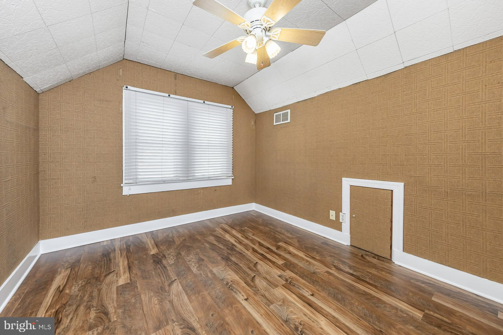 411 Ives Avenue Carneys Point, NJ 08069 - Photo 14 of 19 a view of an empty room with window and wooden floor