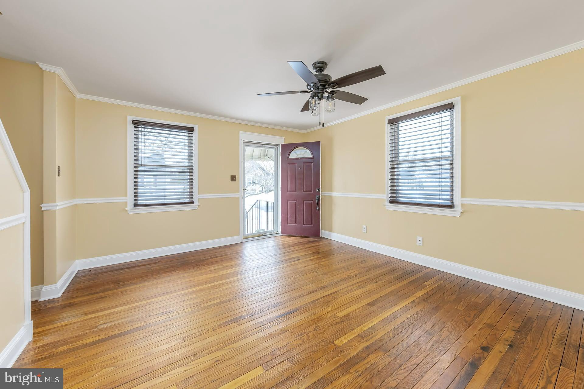 411 Ives Avenue Carneys Point, NJ 08069 - Photo 3 of 19 a view of an empty room with a window and wooden floor