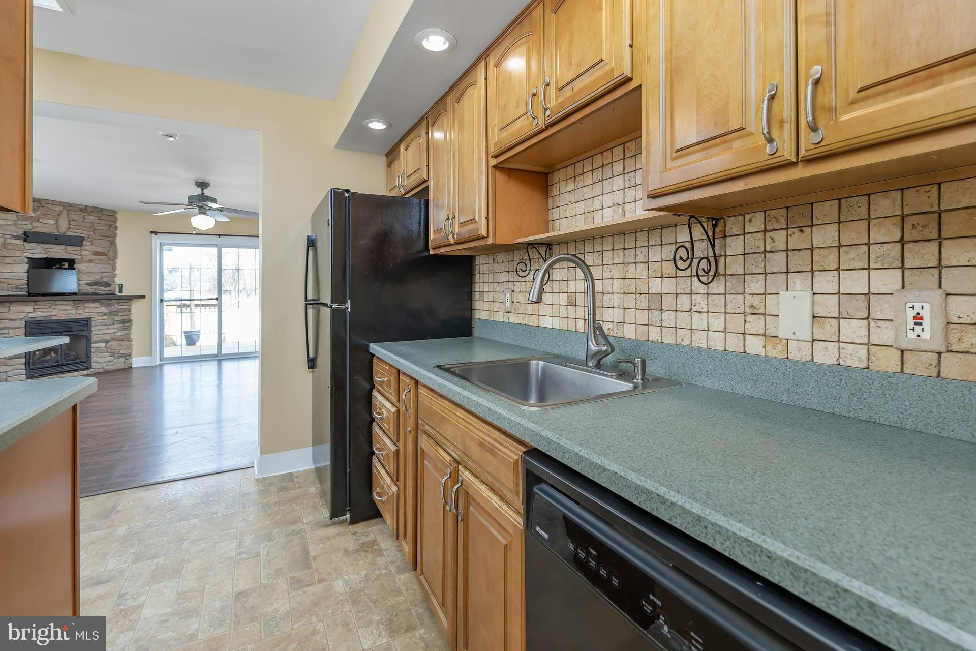 411 Ives Avenue Carneys Point, NJ 08069 - Photo 4 of 19 a kitchen with stainless steel appliances a sink a stove and cabinets