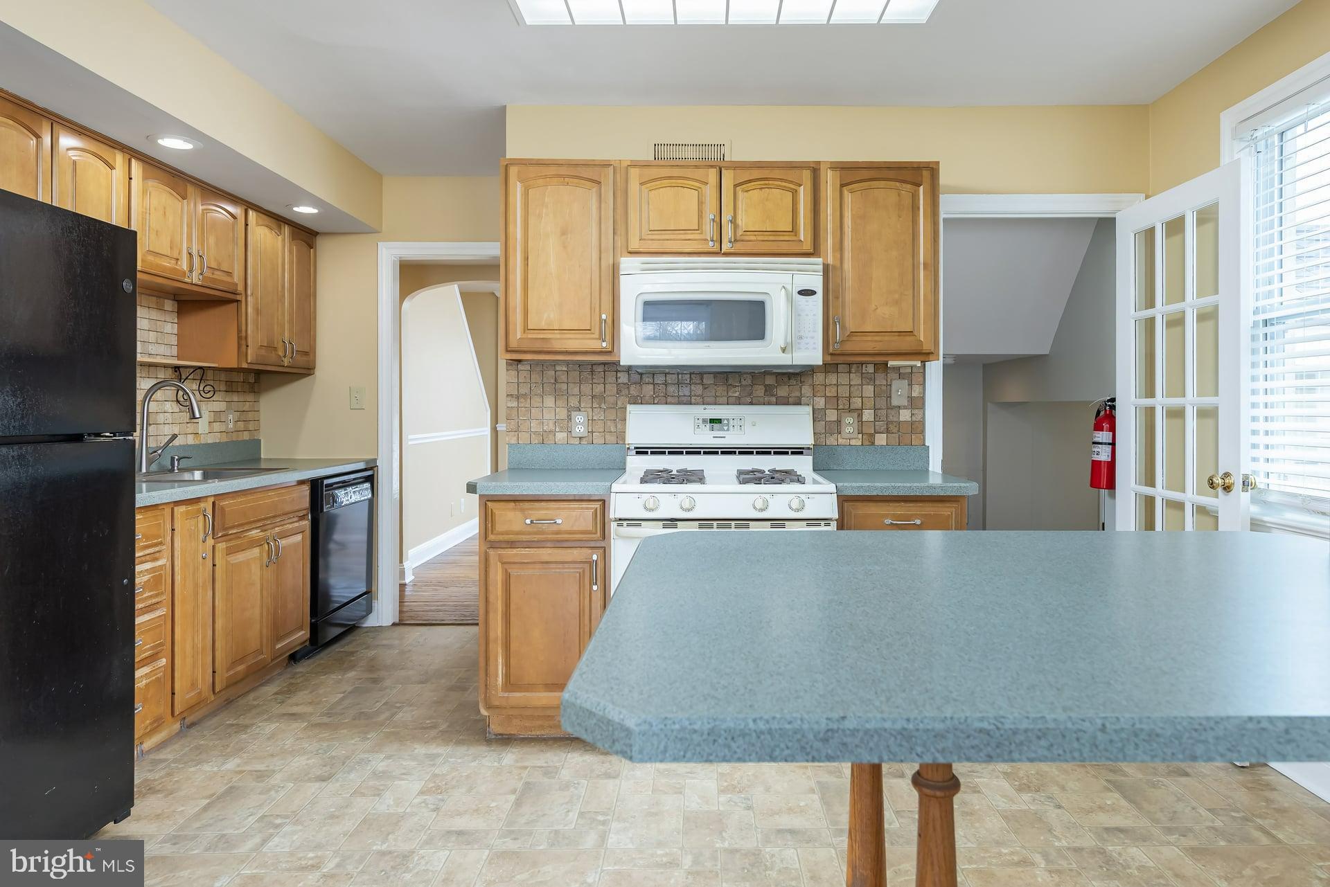 411 Ives Avenue Carneys Point, NJ 08069 - Photo 5 of 19 a large kitchen with stainless steel appliances granite countertop a stove a sink dishwasher a refrigerator and a oven