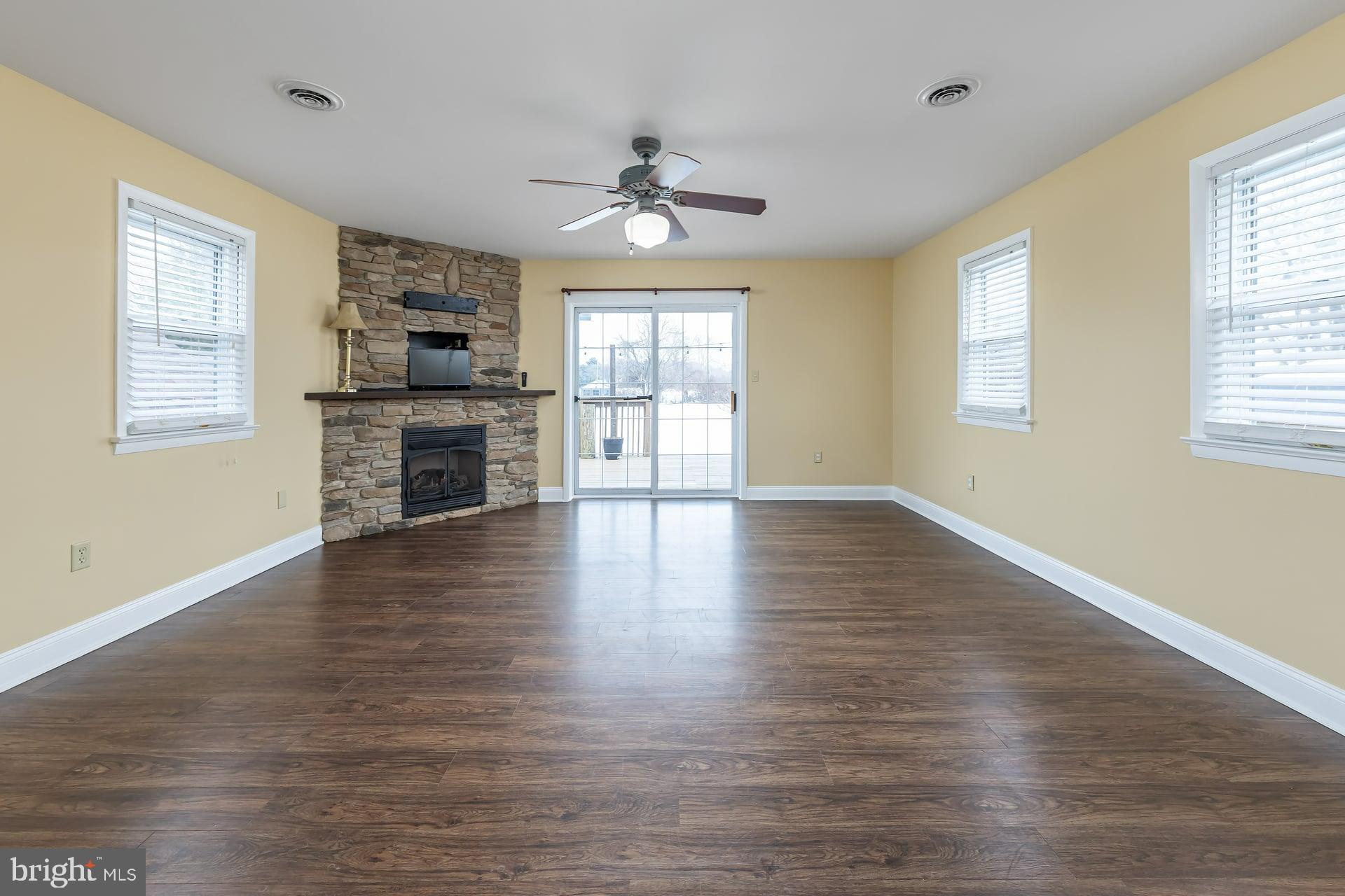 411 Ives Avenue Carneys Point, NJ 08069 - Photo 7 of 19 a view of an empty room with window and wooden floor