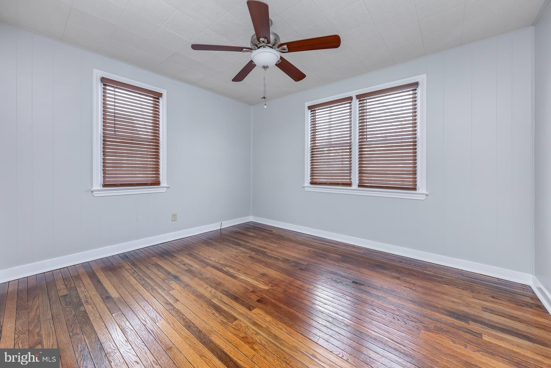411 Ives Avenue Carneys Point, NJ 08069 - Photo 9 of 19 a view of an empty room with wooden floor and a window