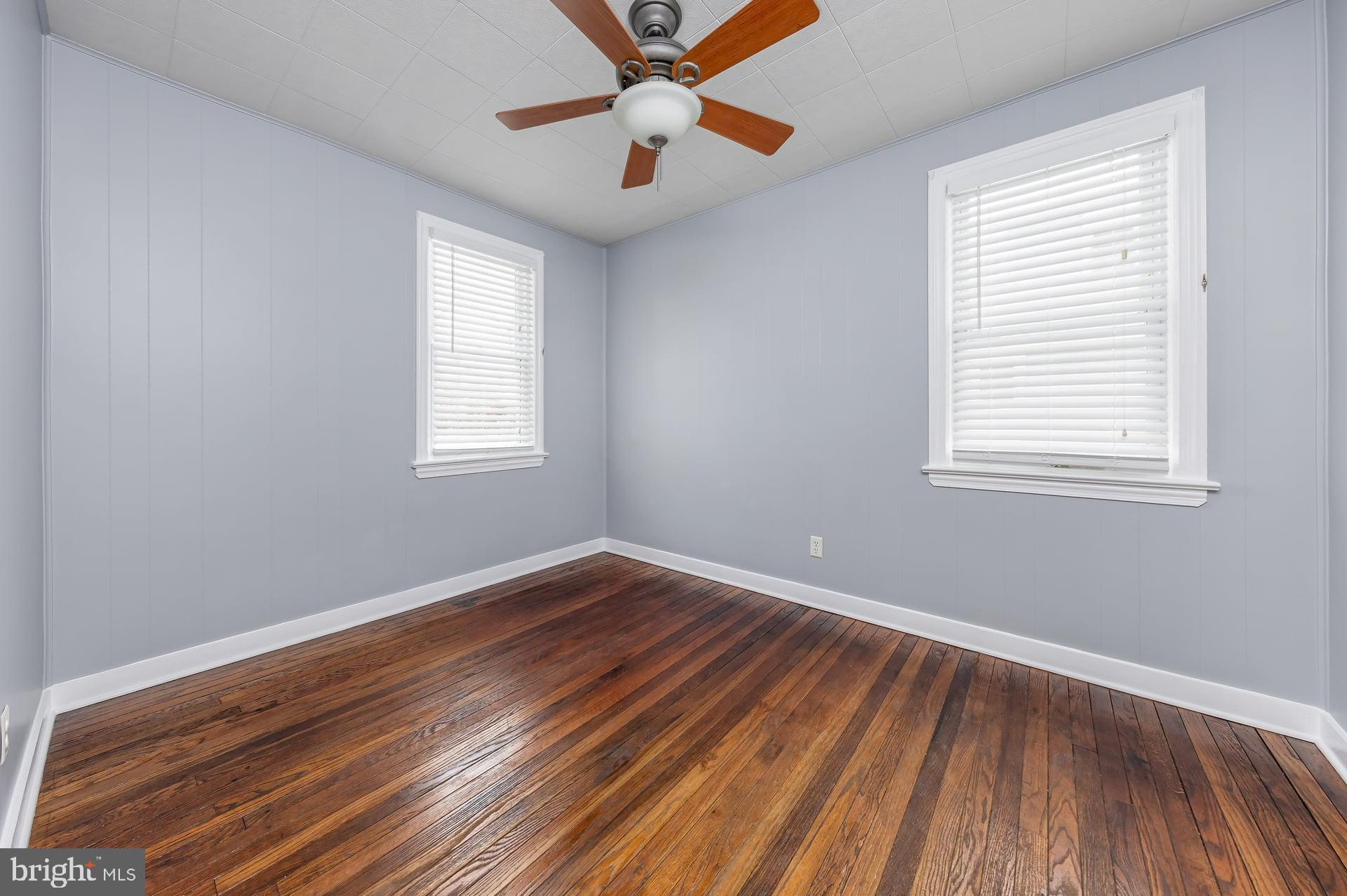 411 Ives Avenue Carneys Point, NJ 08069 - Photo 10 of 19 a view of an empty room with wooden floor and a window