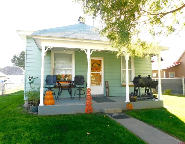 a front view of house with yard and outdoor seating