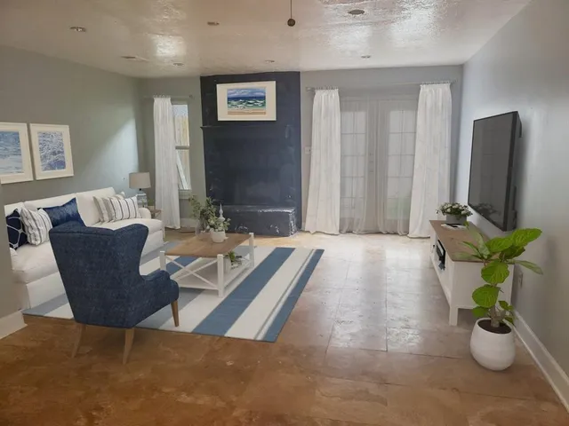 a view of a dining room with furniture and a chandelier