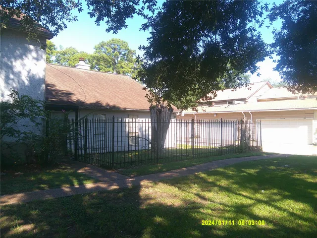 a view of a yard with a large tree