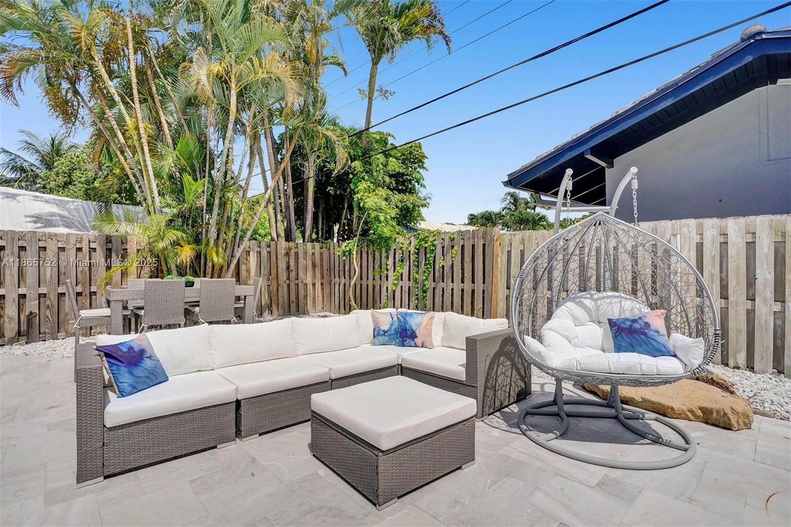3421 Dover Road Pompano Beach, FL 33062 - Photo 23 of 83 a outdoor living space with furniture and a potted plant
