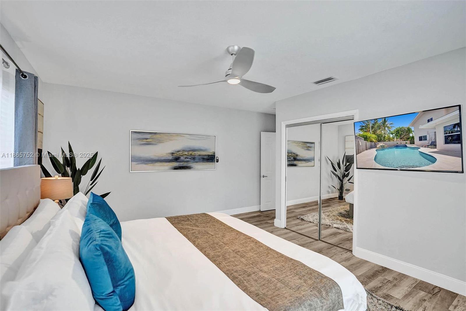 3421 Dover Road Pompano Beach, FL 33062 - Photo 76 of 83 a bedroom with a bed and ceiling fan