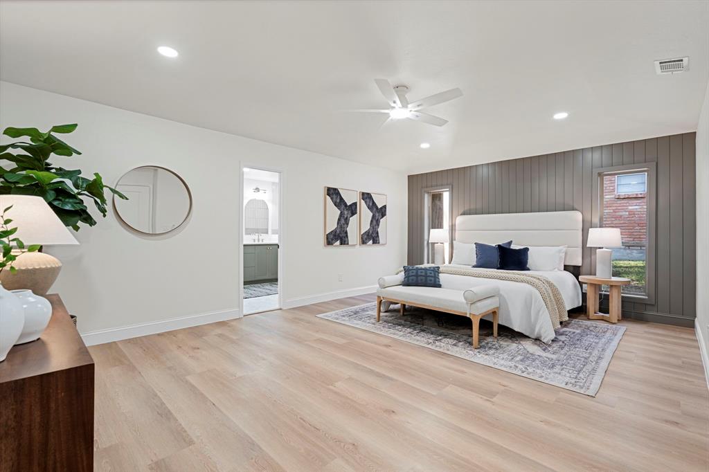 9376 Briarhurst Drive Dallas, TX 75243 - Photo 21 of 38 a bedroom with a large bed and a chandelier