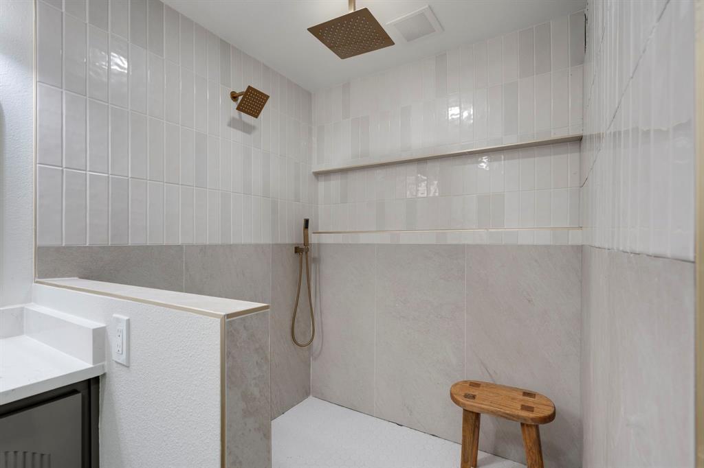 9376 Briarhurst Drive Dallas, TX 75243 - Photo 25 of 38 a bathroom with a shower a toilet and a sink