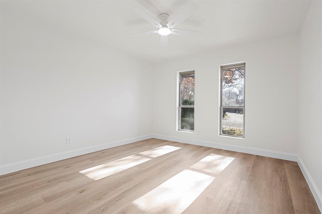 9376 Briarhurst Drive Dallas, TX 75243 - Photo 27 of 38 an empty room with wooden floor and windows